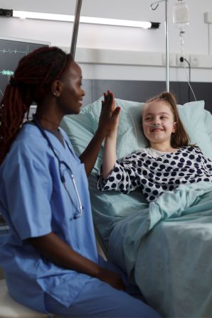 childcare-healthcare-facility-staff-high-fiving-ill-kid-medical-treatment-nurse-doing-high-five-gesture-with-sick-girl-resting-hospital-pediatric-ward-patient-bed
